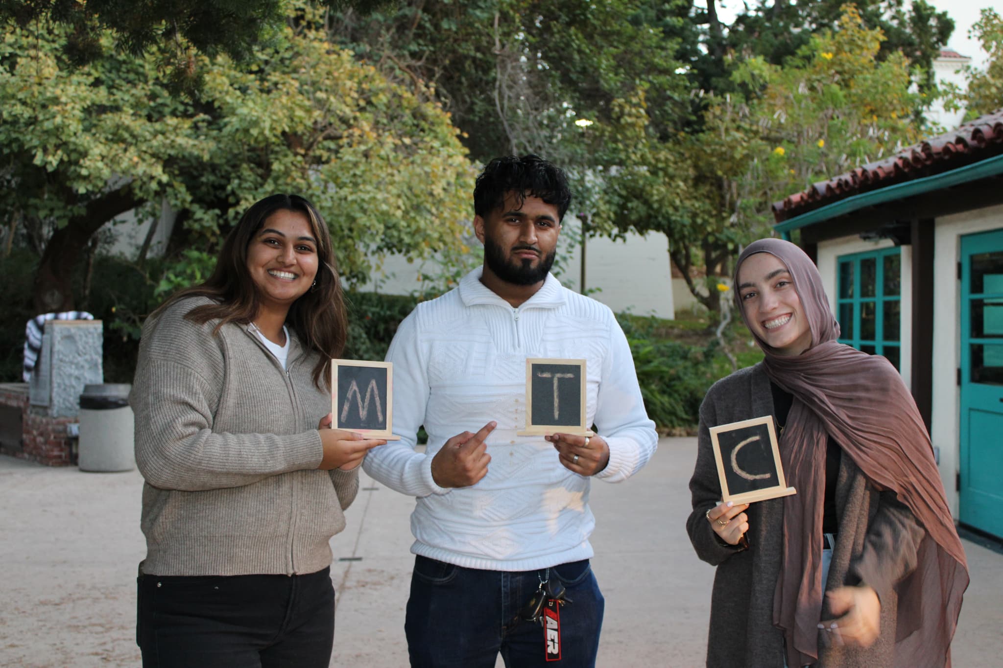 Image of students huddled up for a group photo